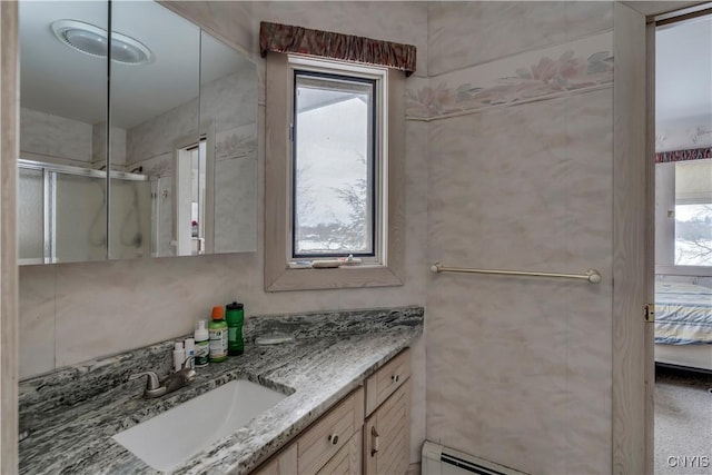 bathroom with vanity and a shower with shower door