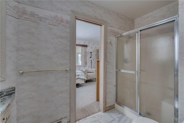 bathroom featuring a shower with door and vanity