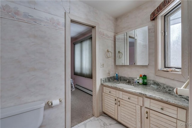 bathroom featuring vanity, toilet, and a baseboard heating unit