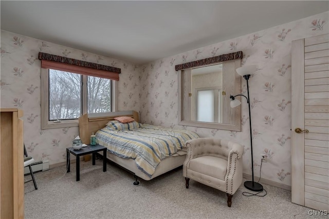 bedroom with carpet and a baseboard heating unit