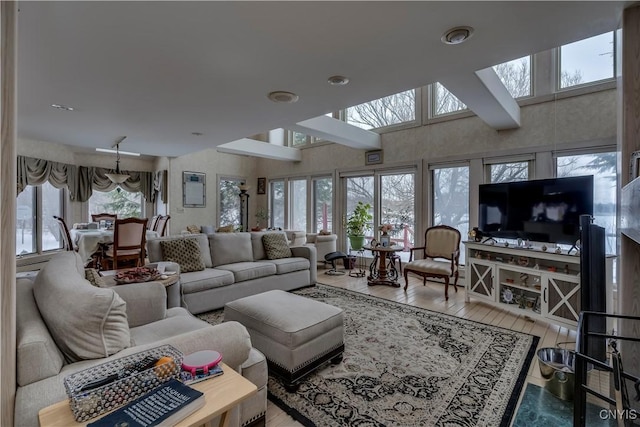 living room with hardwood / wood-style floors and a high ceiling