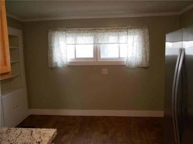 unfurnished dining area with crown molding and dark wood-type flooring