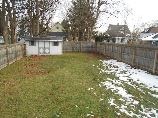 yard covered in snow with a shed