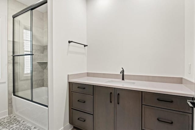 bathroom with vanity and enclosed tub / shower combo