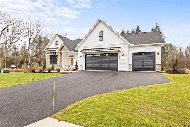 modern farmhouse featuring a garage and a front lawn