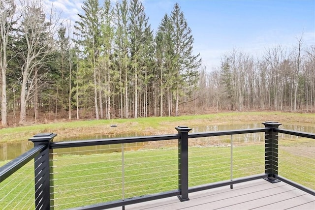 wooden deck featuring a lawn and a water view