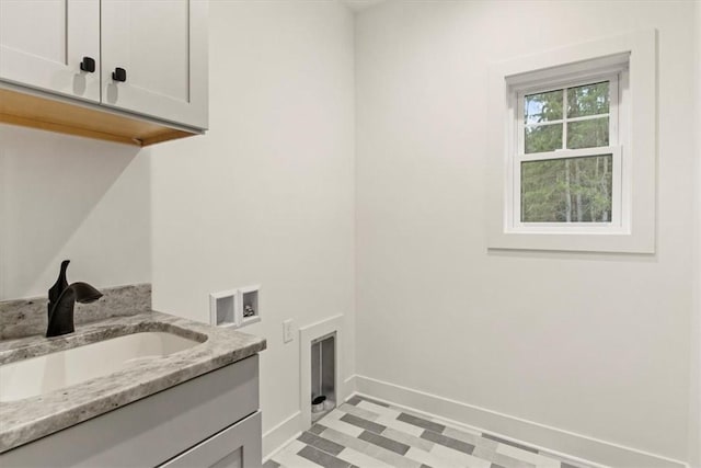 laundry area featuring cabinets, washer hookup, and sink