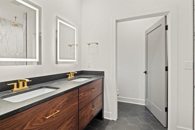 bathroom featuring tile patterned flooring, vanity, toilet, and a shower