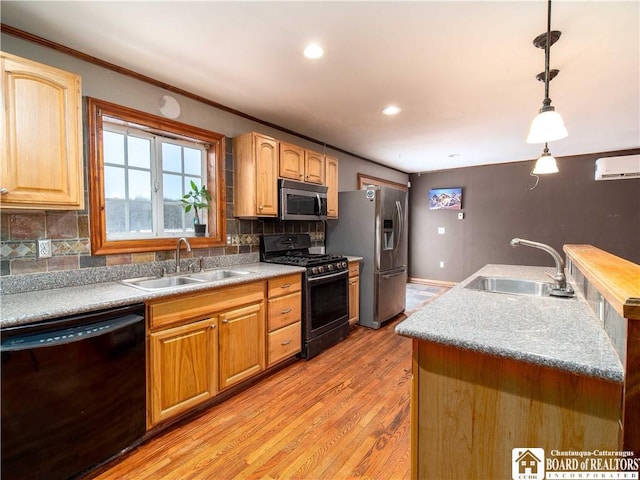 kitchen featuring decorative backsplash, sink, decorative light fixtures, and black appliances