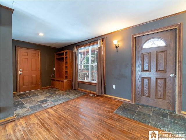 entrance foyer featuring dark hardwood / wood-style floors and ornamental molding