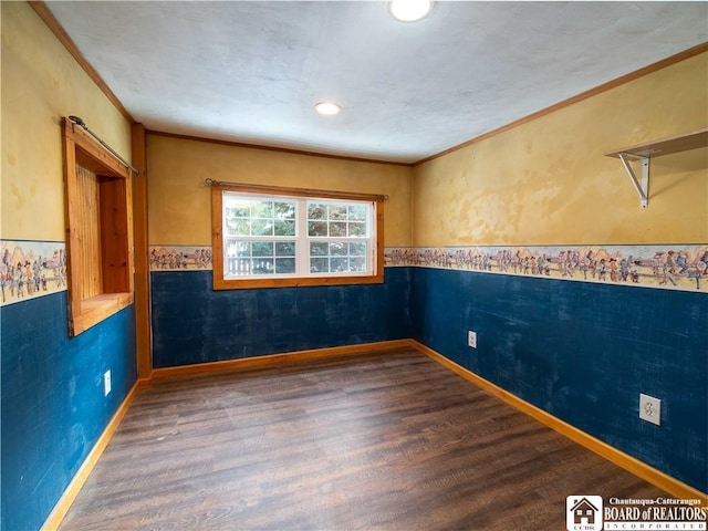 unfurnished room featuring ornamental molding and dark wood-type flooring