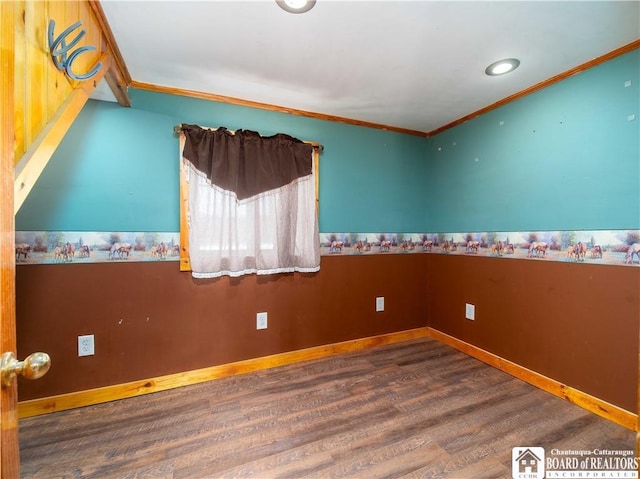 empty room with hardwood / wood-style flooring and crown molding