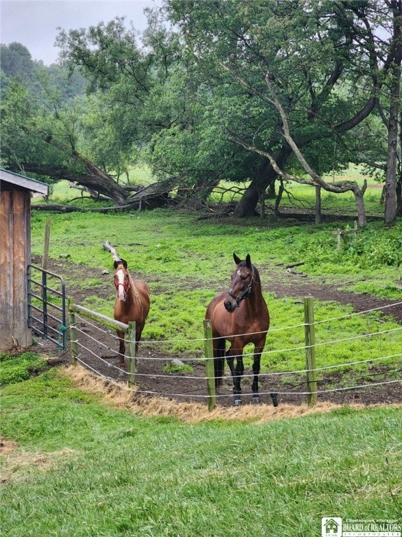 view of stable featuring a rural view