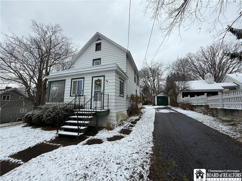 view of front of home with a garage and an outdoor structure