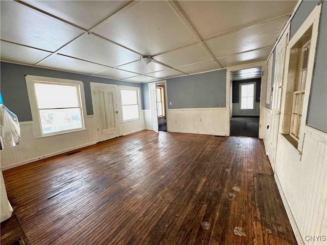 spare room with hardwood / wood-style floors and plenty of natural light