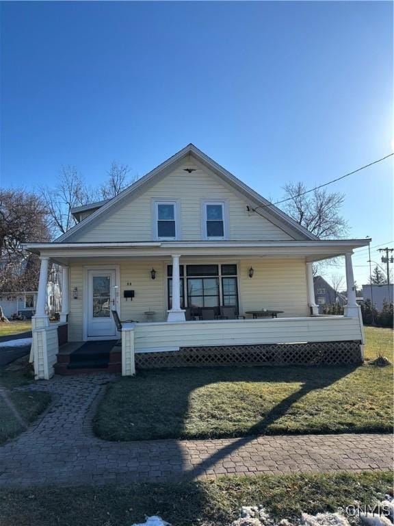 bungalow featuring a front lawn and a porch