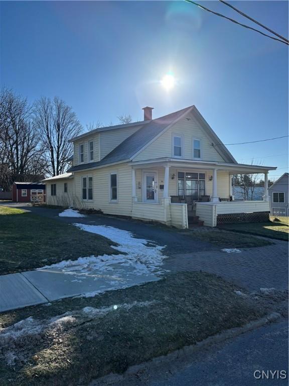 view of front of house with covered porch and a front yard