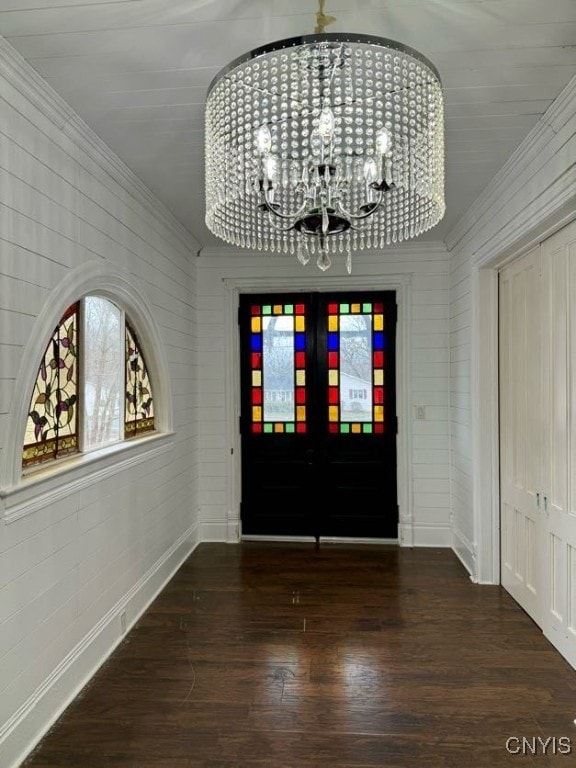 foyer featuring a chandelier, french doors, and dark hardwood / wood-style flooring