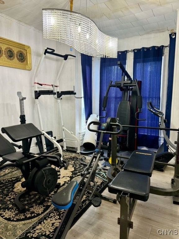 exercise area with a notable chandelier