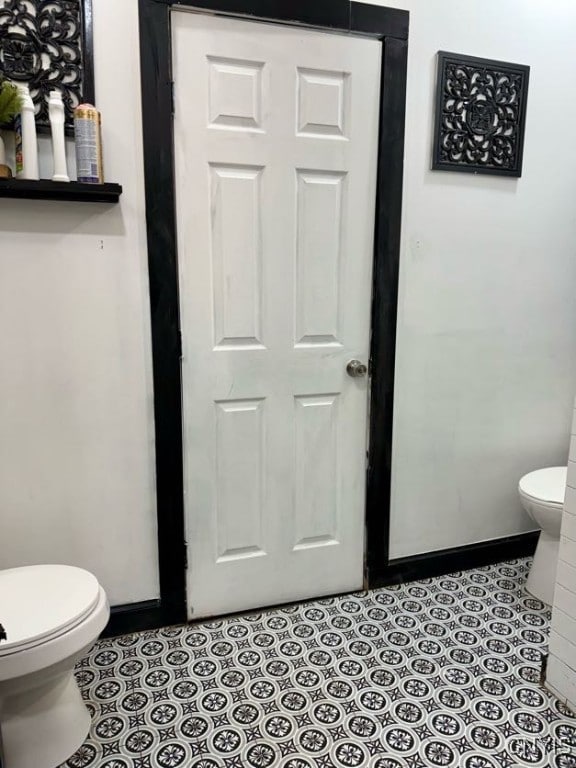 bathroom featuring tile patterned floors and toilet