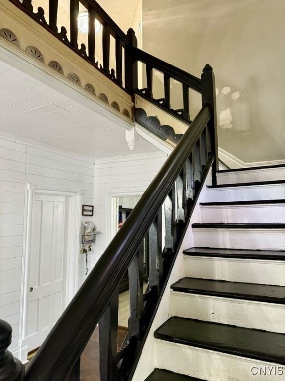 stairs featuring wooden walls