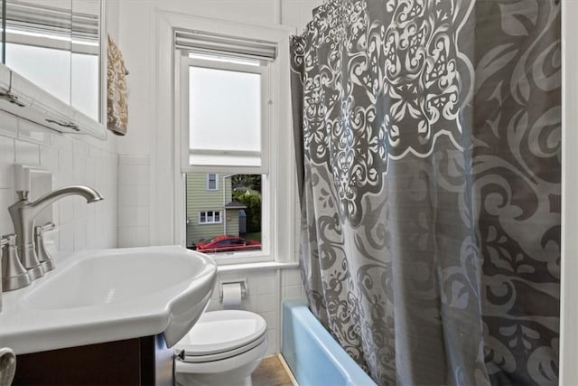 full bathroom with vanity, backsplash, shower / bath combination with curtain, toilet, and tile walls