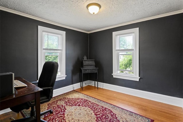 home office featuring a textured ceiling, plenty of natural light, and crown molding