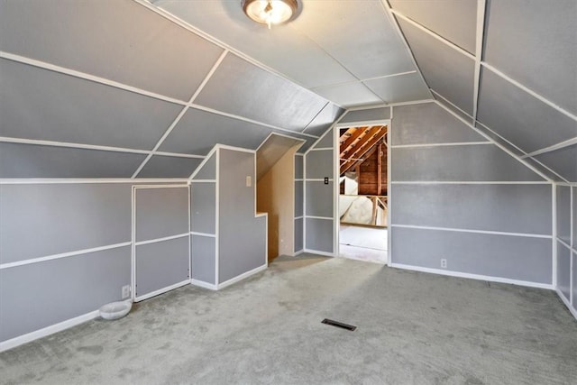 bonus room featuring carpet floors and vaulted ceiling