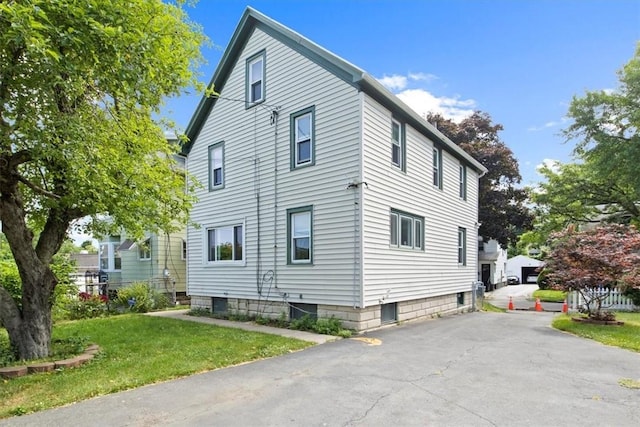 view of property exterior featuring a lawn