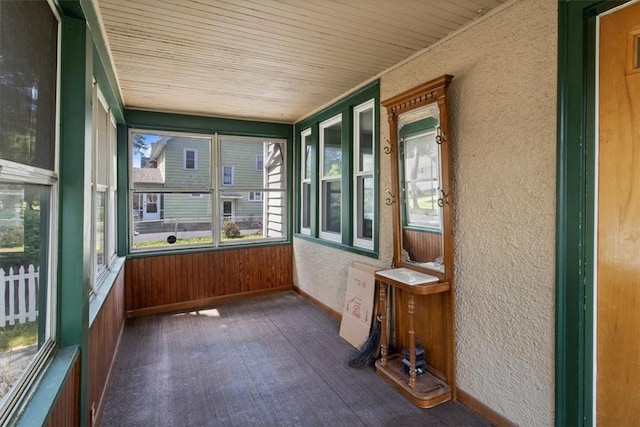 unfurnished sunroom with wooden ceiling