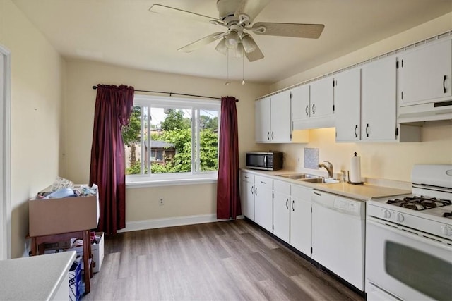 kitchen with range hood, white cabinets, white appliances, and sink