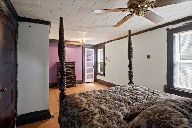 bedroom with ceiling fan, light hardwood / wood-style floors, and crown molding