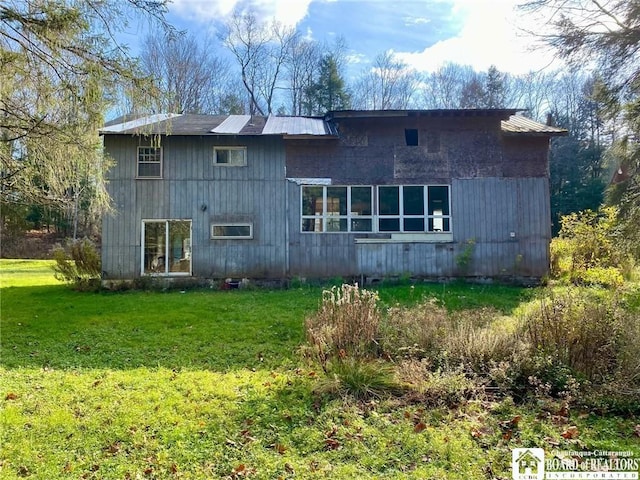 rear view of house with a lawn