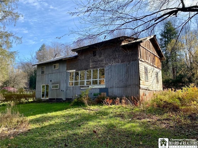 rear view of property with a yard