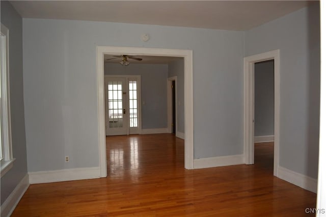 unfurnished room featuring ceiling fan, wood-type flooring, and french doors