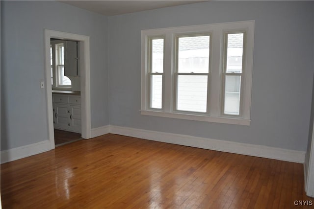 unfurnished room featuring hardwood / wood-style flooring