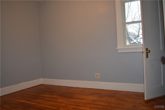 empty room featuring dark wood-type flooring