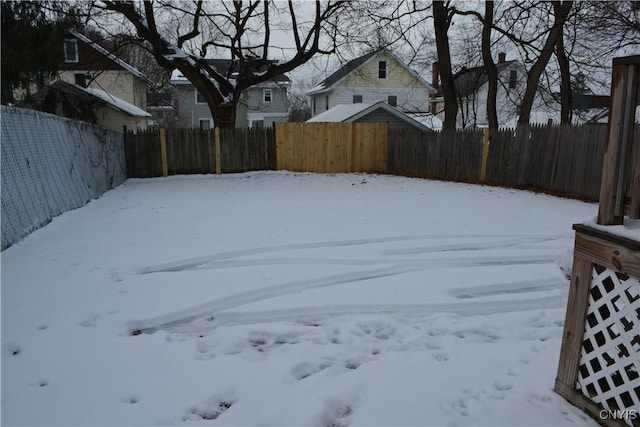 view of yard layered in snow