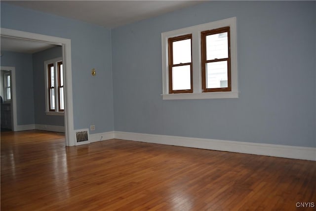 unfurnished room featuring dark hardwood / wood-style flooring