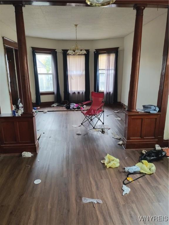 misc room with an inviting chandelier, dark hardwood / wood-style flooring, and decorative columns