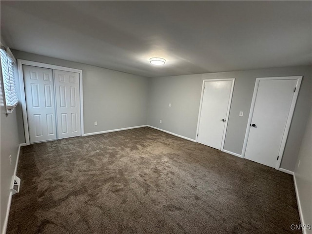 unfurnished bedroom featuring dark colored carpet