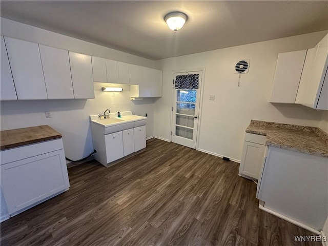 kitchen featuring white cabinetry, sink, and dark wood-type flooring