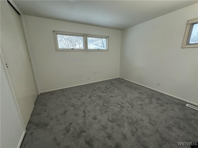 empty room with dark carpet