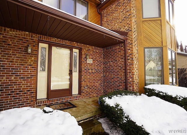 view of snow covered property entrance