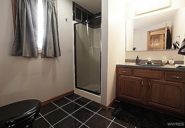 bathroom featuring toilet, vanity, and a shower with door