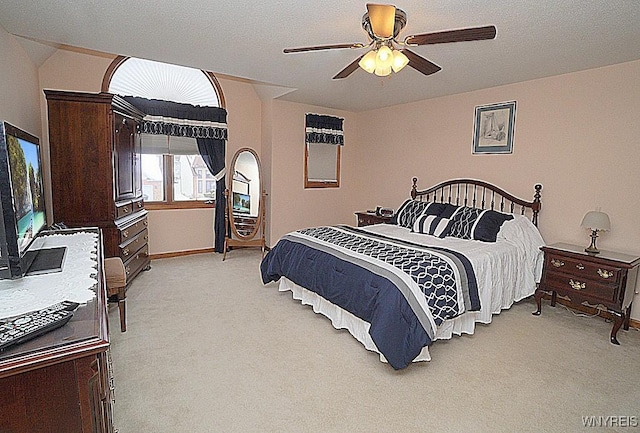 carpeted bedroom featuring a textured ceiling and ceiling fan