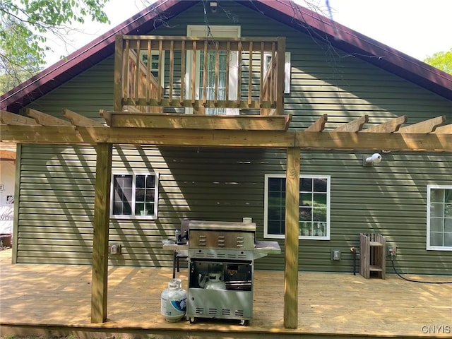 rear view of house with a pergola and a deck