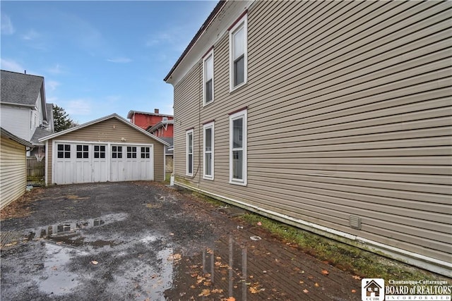 view of side of property featuring an outbuilding and a garage