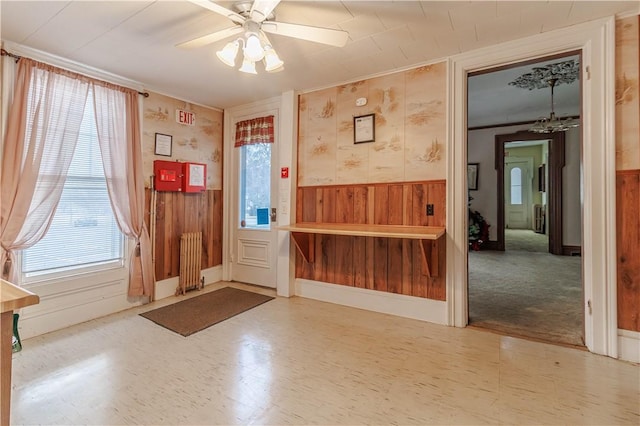 248 W Ave, Clarkson, NY 14420 - entryway featuring radiator, a wainscoted wall, plenty of natural light, a ceiling fan, and wood walls