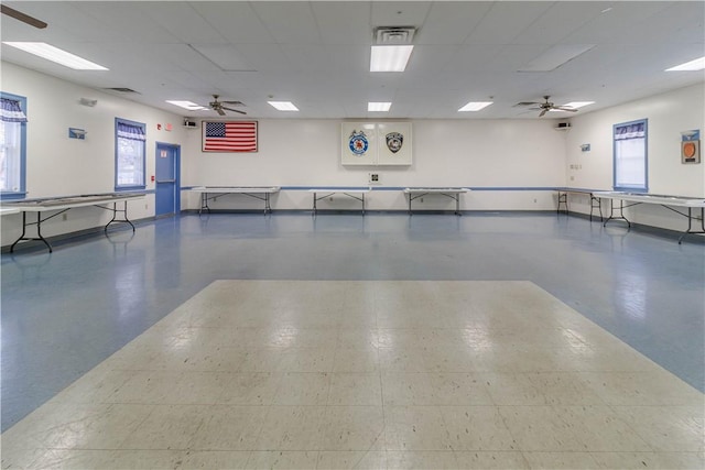 interior space with ceiling fan